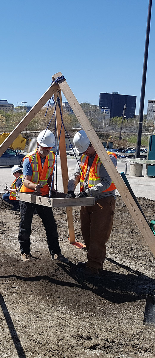two men sifting the earth